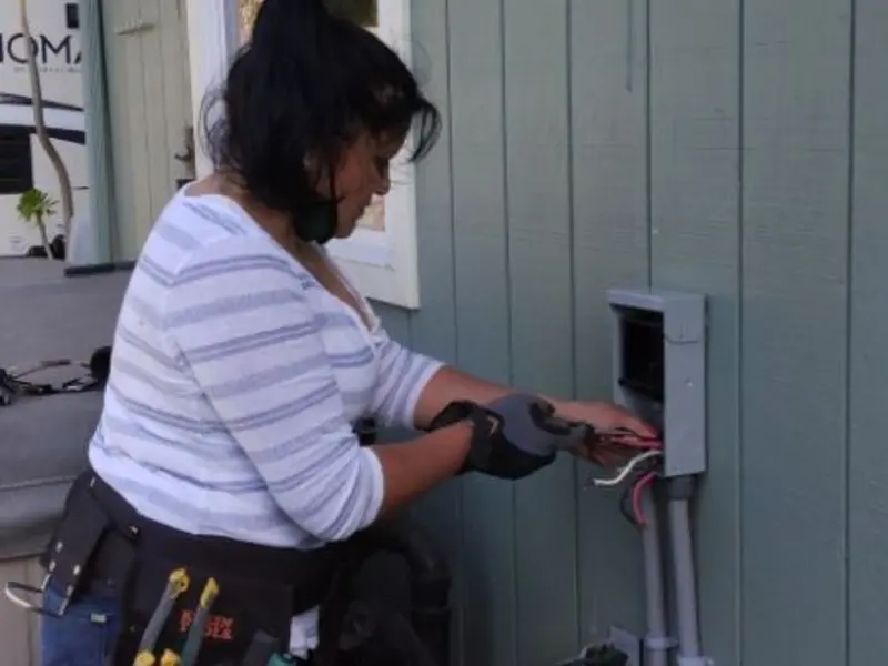 Licensed electrician wiring an exterior subpanel in Kirkland